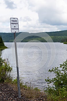 Private Property No Trespassing Sign on Old Train Tracks Rail Path Forest Clouds