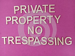 Private property no trespassing sign on a pink background