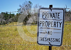 Private Property Sign on Barbed Wire Fence