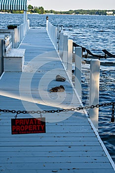Private Property sign on a dock with ducks
