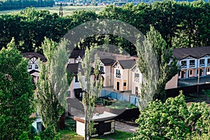 Private residential townhouses. Modern housing in the countryside in green foliage. Ideal family plot.