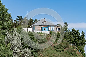 A private residential wooden house with an attic is built and is located on the mountain.