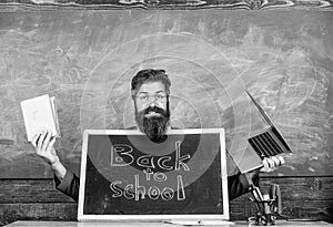 Private school advertising boost enrollments. Teacher or school principal welcomes blackboard inscription back to school