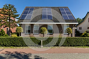 Private solar panels on a detached bungalow family house on the roof.