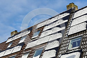 Private solar panels with melting snow on the roof