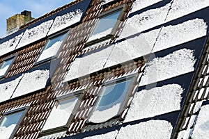 Private solar panels with melting snow on the roof