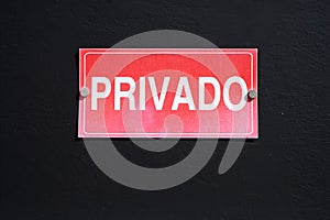Private, Spainsh word `privado`, on a red plate. photo