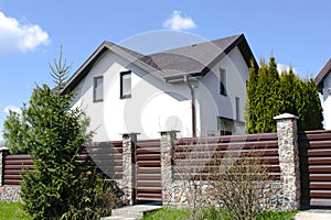 private suburban house with backyard behind high fence. beautiful landscape recreation cottage complex in ecological