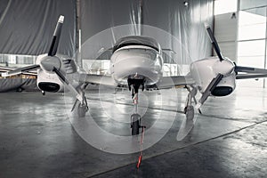 Private turbo-propeller airplane in hangar, nobody