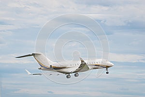 A private white small business jet comes in for a landing. Jet corporate business aviation. Business jet against the