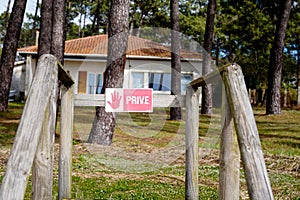 PrivÃ© means in french Sign Private Property on a wooden gate