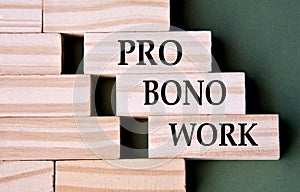 PRO BONO WORK - words on wooden blocks on dark green background photo