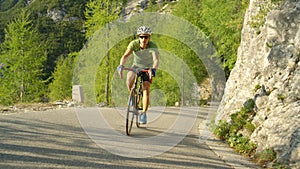 Pro road cyclist training for a race through the sunny mountains in Slovenia.