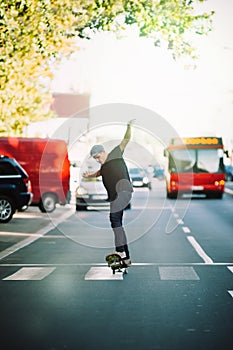 Pro skateboarder ride skateboard on capital road street through