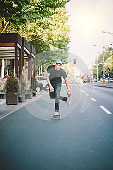 Pro skateboarder ride skateboard on capital road street through