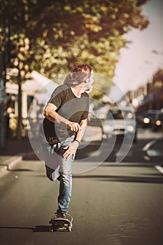 Pro skateboarder ride skateboard on capital road street through