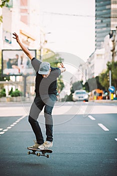 Pro skater doing tricks and jumps on street. Free ride