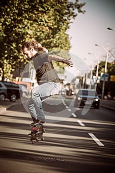 Pro skater doing tricks and jumps on street. Free ride