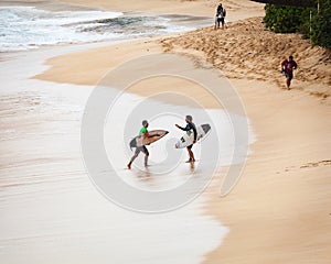 Pro Surfers Walking at Sunset Beach Hawaii