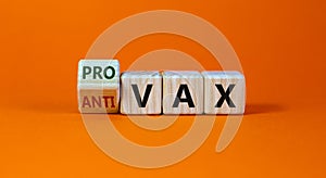 Pro-vax or anti-vax symbol. Turned a cube, changed words `anti-vax` to `pro-vax`. Beautiful orange background. Copy space. photo