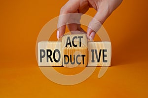 Proactive and Productive symbol. Businessman hand turns wooden cubes and changes the word Productive to Proactive. Beautiful