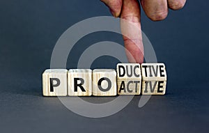 Proactive and productive symbol. Businessman turns cubes and changes the concept word Productive to Proactive. Beautiful grey