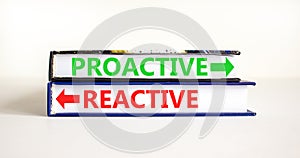 Proactive and reactive symbol. Concept word Proactive Reactive on beautiful books. Beautiful white table white background.