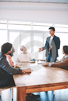 Proactive teams are productive teams. a group of young businesspeople having a meeting in a modern office.