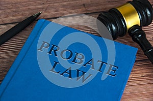 Probate law book with gavel and pen on wooden table. Law concept