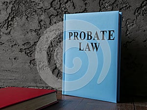 Probate law book near the dark wall.