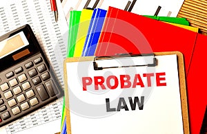 PROBATE LAW text on clipboard with calculator and color folder