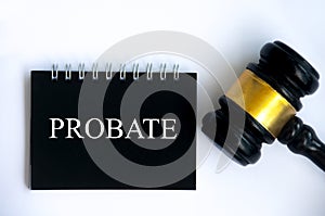 Probate text on black notepad and gavel on white cover background.