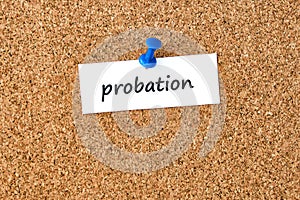Probation. Word written on a piece of paper, cork board background photo