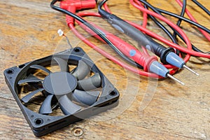 Probes for a multimeter and electronic components on a table in a workshop