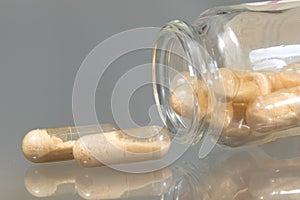 Probiotics capsules on the glass bottle photo
