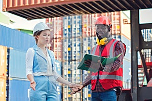The Problem with businesswoman and engineer talking and checking loading Containers box from Cargo freight ship for import export