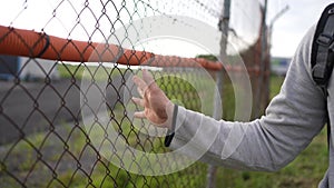 problem is an illegal immigrant or an undocumented person the man's hand slides over the border barrier