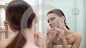 Problem Skin. Woman Crushing Spot On Face And Looking In Mirror