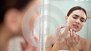 Problem Skin. Woman Crushing Spot On Face And Looking In Mirror