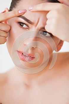 Problem Skin. Woman Crushing Spot On Face And Looking In Mirror