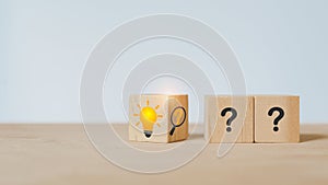 Problem solving, idea, business strategy, solution concept, flip wooden cube block, question mark inside magnifying glass to