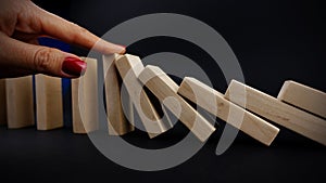 Problem solving with smart decision, businesswoman stopping domino effect on dark background