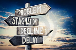 Problem, stagnation, decline, delay - wooden signpost, roadsign with four arrows