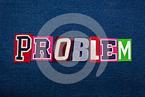 PROBLEM text word collage, multi colored fabric on blue denim, problem or challenge concept