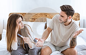 Problems with conceiving concept. Frustrated husband and wife sitting on bed