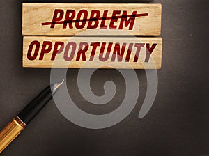 Problems crossed out and opportunity on wooden blocks. Business startup concept