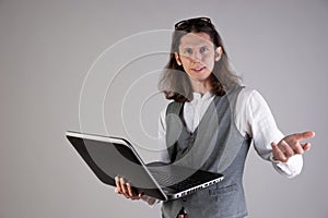 Problems with equipment, computer failure. Service for a laptop. A young man holds a laptop in his hands,