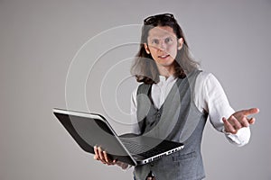 Problems with equipment, computer failure. Service for a laptop. A young man holds a laptop in his hands,