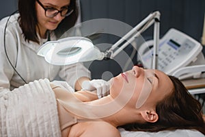 Procedure of armpit electrolysis in beauty clinic