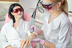 Procedure of hands laser hair removing beautician specialist.